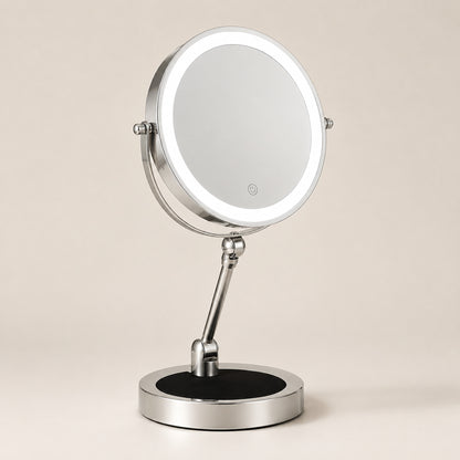 Silver lighted tabletop makeup mirror on a warm ivory background