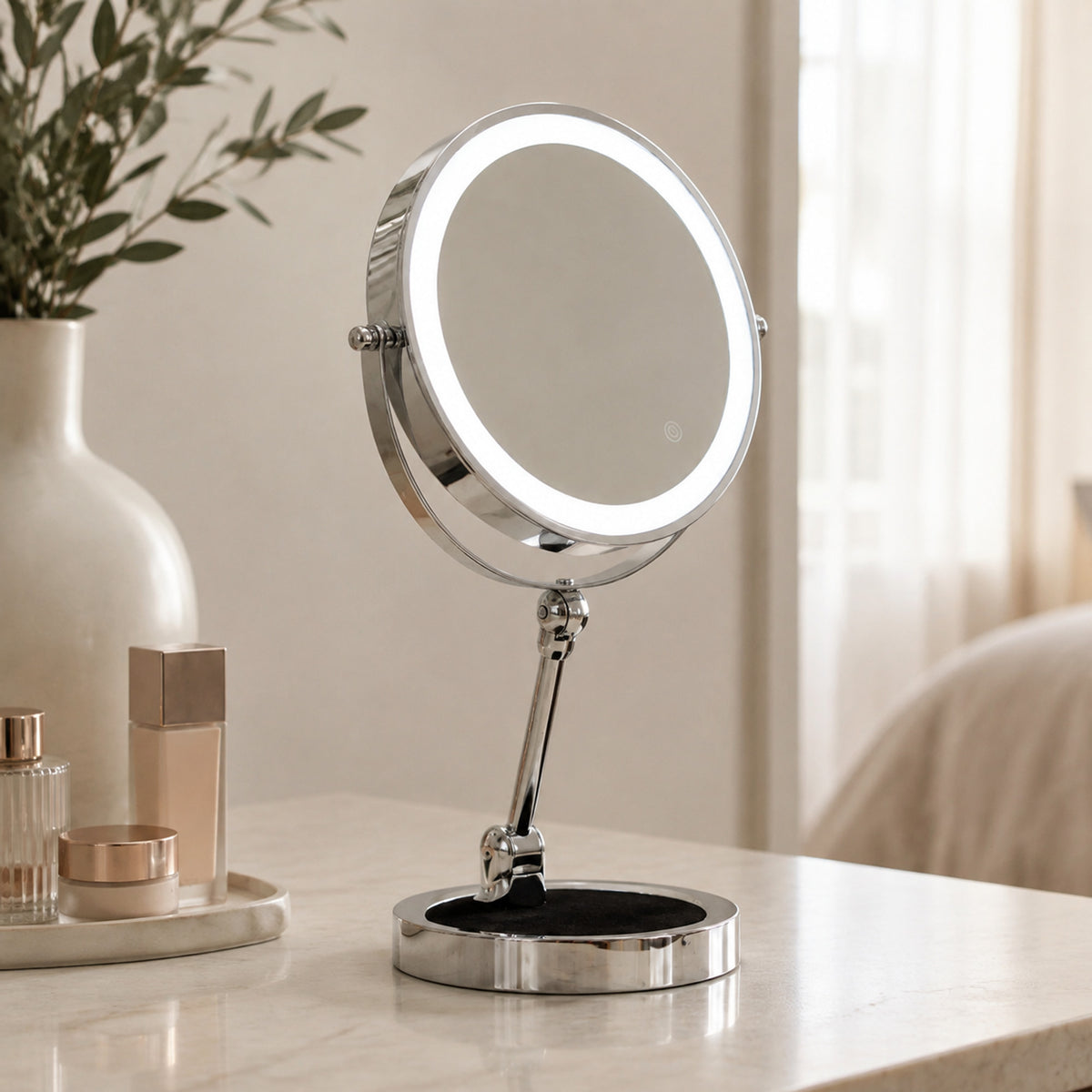 Silver lighted makeup mirror on a refined bedroom dressing table