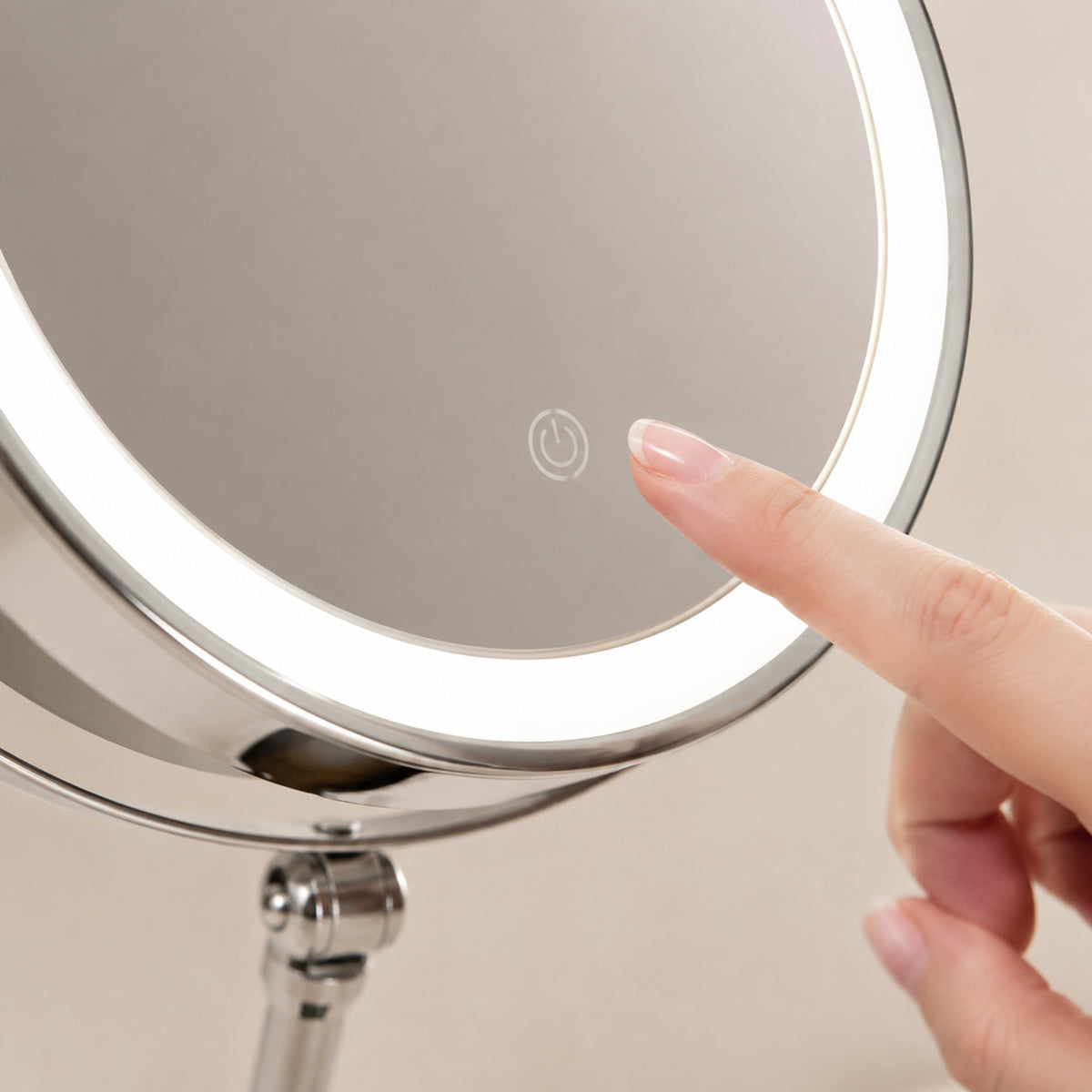 Close-up of the touch control on a Silver lighted makeup mirror
