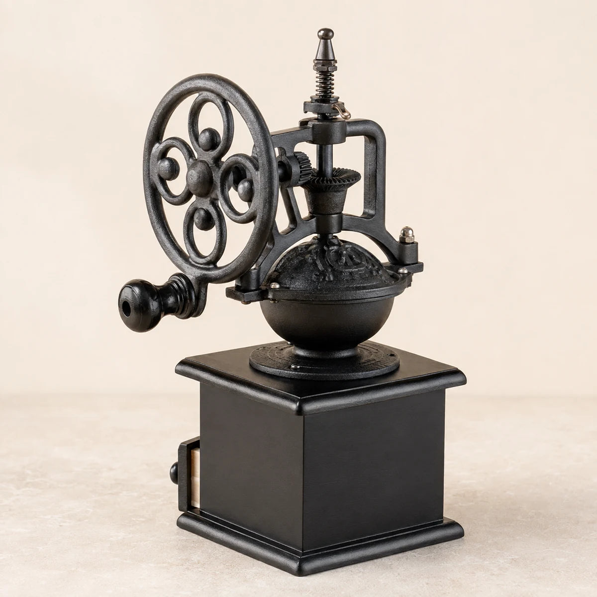 Rear three-quarter view of a hand-crank coffee grinder