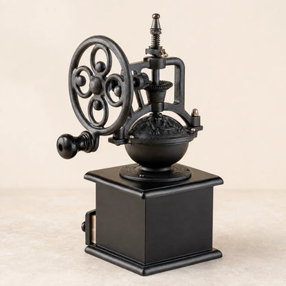Rear three-quarter view of a hand-crank coffee grinder