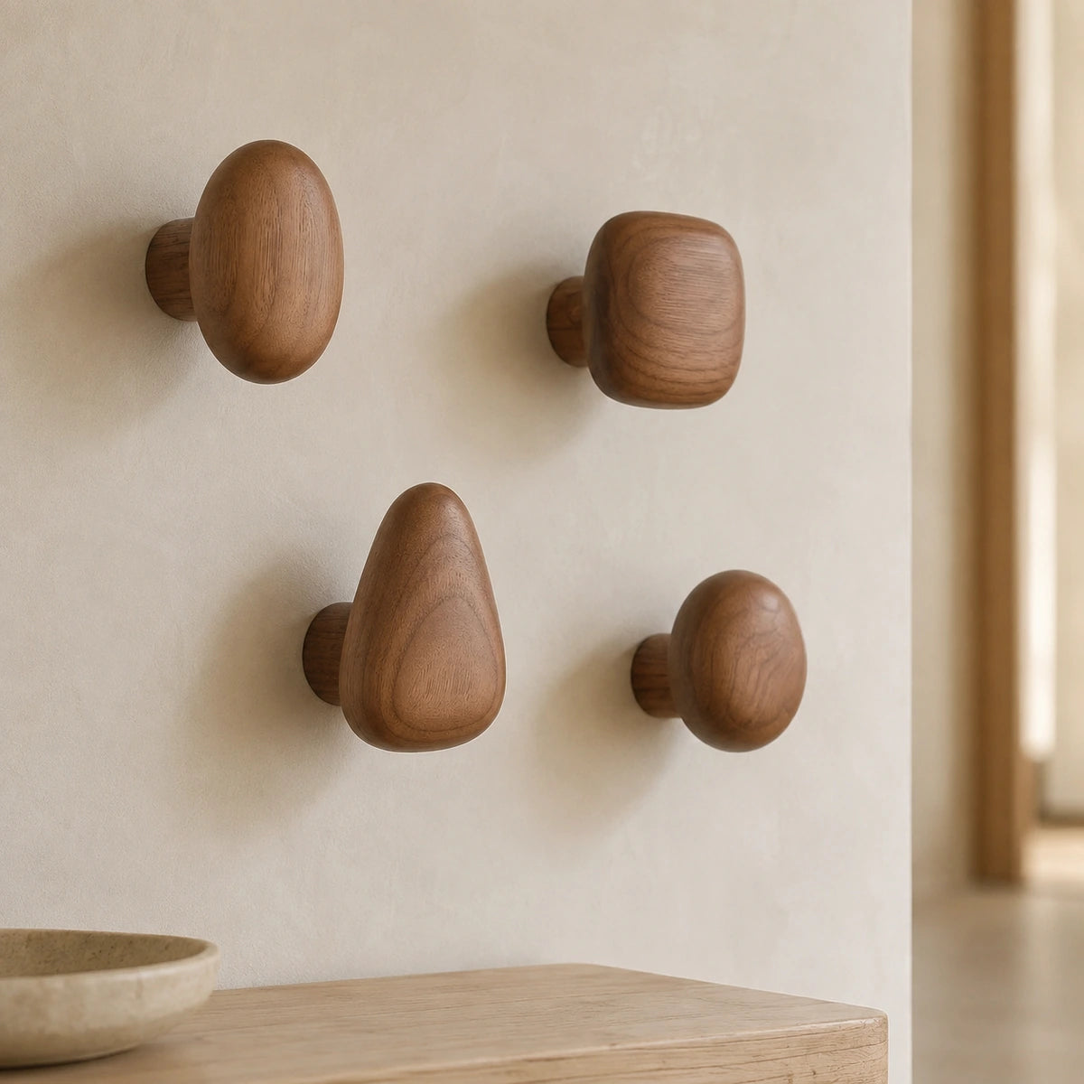 Walnut Wood pebble wall hooks in a warm modern hallway