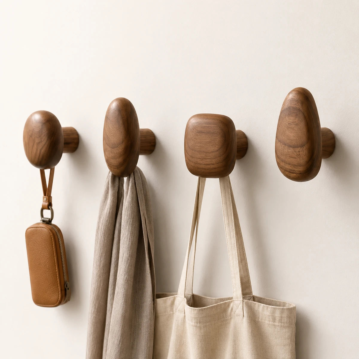 Walnut Wood pebble wall hooks holding everyday accessories