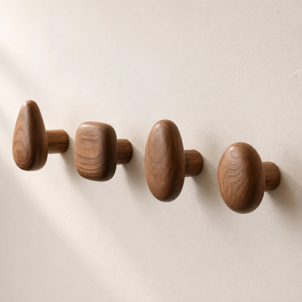 Angled view of Walnut Wood hooks showing their cylindrical mounts