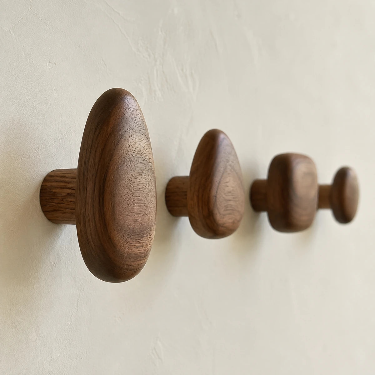 Side detail of an installed Walnut Wood pebble wall hook
