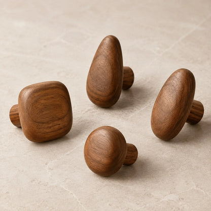 Set of four Walnut Wood pebble hooks arranged on a simple studio background