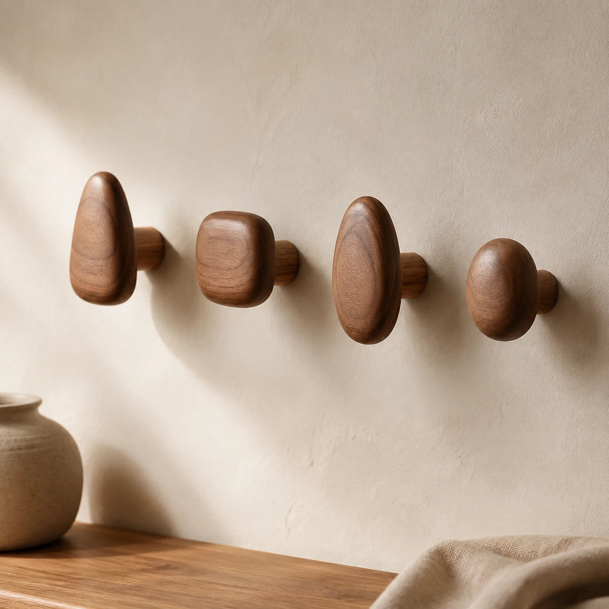 Walnut Wood pebble wall hooks in a minimalist entryway
