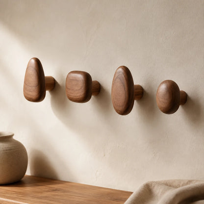 Walnut Wood pebble wall hooks in a minimalist entryway