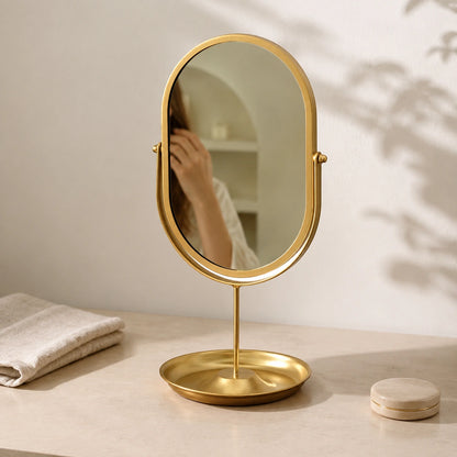 Gold oval vanity mirror in an elegant daily grooming setting