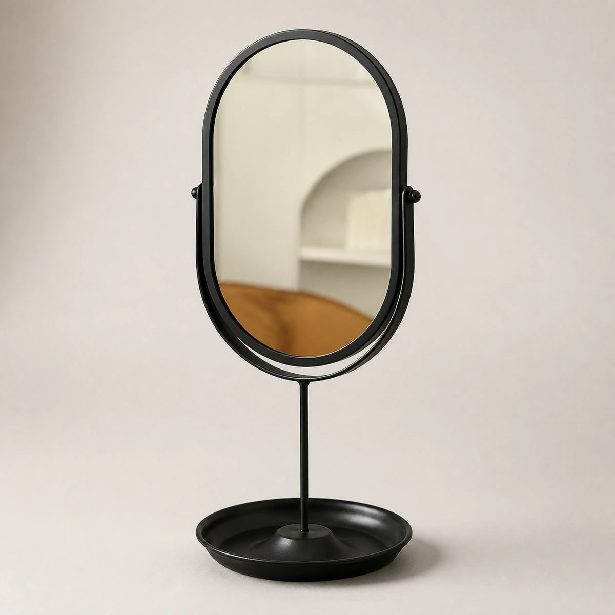 Black oval vanity mirror on a clean contrasting background