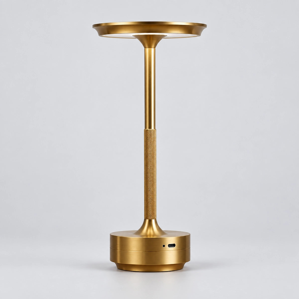 Gold rechargeable touch table lamp on a light grey background