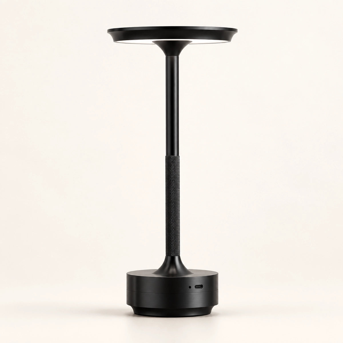 Black rechargeable touch table lamp on a warm white background