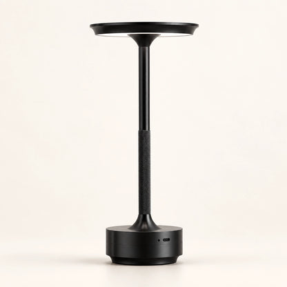 Black rechargeable touch table lamp on a warm white background