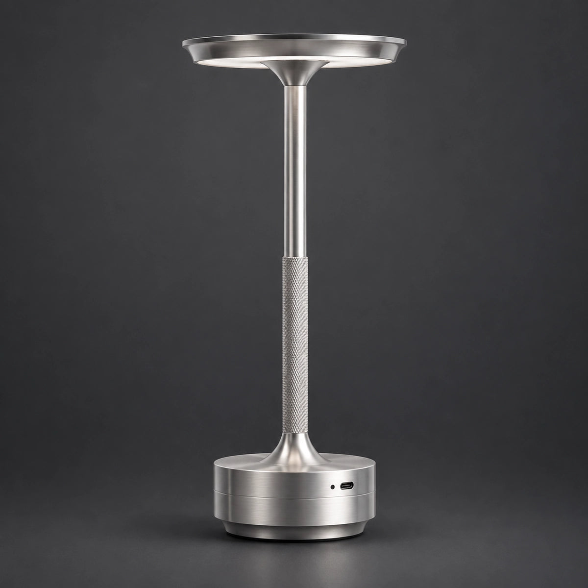 Silver rechargeable touch table lamp on a charcoal background