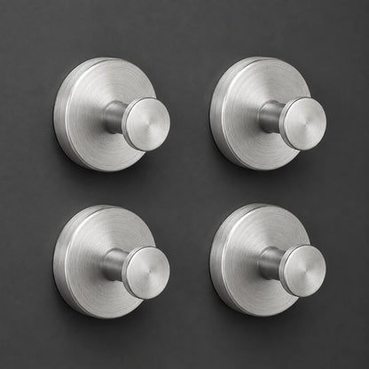 Set of four Silver vacuum suction wall hooks on charcoal-gray tile
