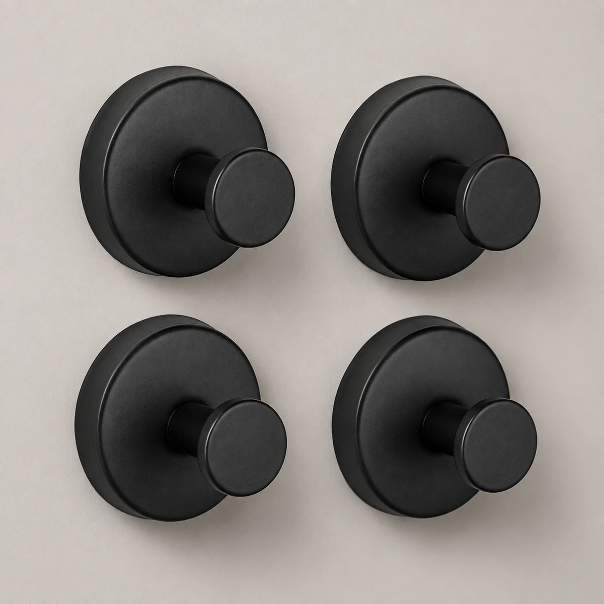 Four Matte Black vacuum suction hooks in a clean product composition