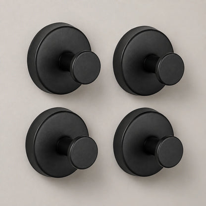 Four Matte Black vacuum suction hooks in a clean product composition